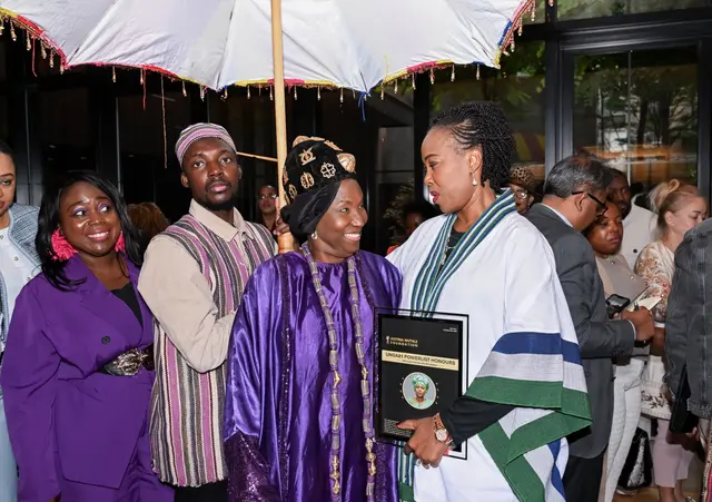 H.E. Rev. Dr. Ocansey shares a moment with guests beneath the ceremonial umbrella